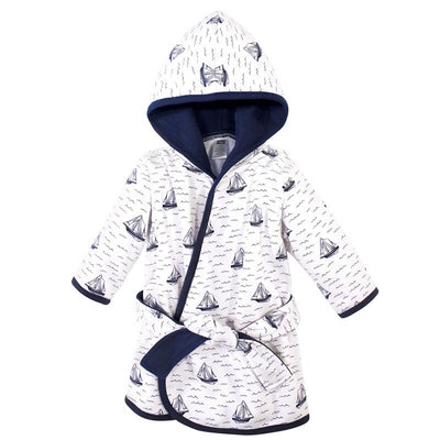 Unisex baby bathrobe in cotton rich fabric, featuring a sailboat print and a hood, with a navy trim and belt.
