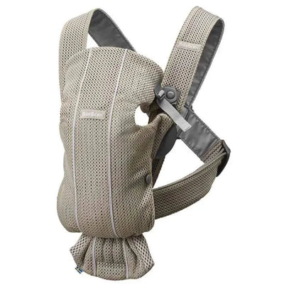 Babybjorn Baby Carrier Mini in Gray Beige, featuring 3D mesh material with adjustable straps and a compact design for carrying infants.