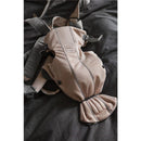 BabyBjörn Baby Carrier Mini in 3D mesh, Pearly Pink, displayed on a dark surface, highlighting its breathable fabric and adjustable straps.