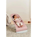 Babybjorn Bouncer Bliss in dusty pink, featuring a baby wearing a white outfit, comfortably seated and engaged.