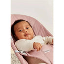 Babybjorn Bouncer Bliss in Dusty Pink, featuring a baby comfortably seated, wearing a light-colored long-sleeve shirt.