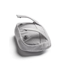 Light gray BabyBjörn Pocket Pouch for baby carrier, featuring adjustable straps and button closures.