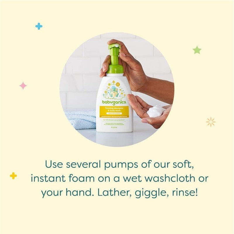 Babyganics fragrance-free baby shampoo and body wash pump bottle held in one hand, with foam in the other hand, on a light background.