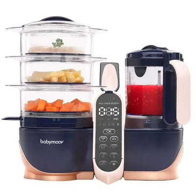 Babymoov Duo Meal Station XL, a 6-in-1 food processor with steamer, blender, and control panel, featuring visible food ingredients.
