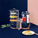 Babymoov Duo Meal Station XL 6-in-1 food processor, featuring a steamer, blender, and a plated meal of vegetables and rice.