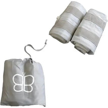 Inflatable bed bumpers in gray, rolled up and stored with a drawstring bag featuring a butterfly logo.
