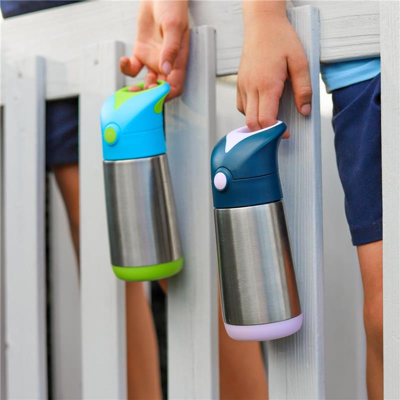 Insulated BBox water bottles in green and blue, held by children, displayed on a wooden fence.