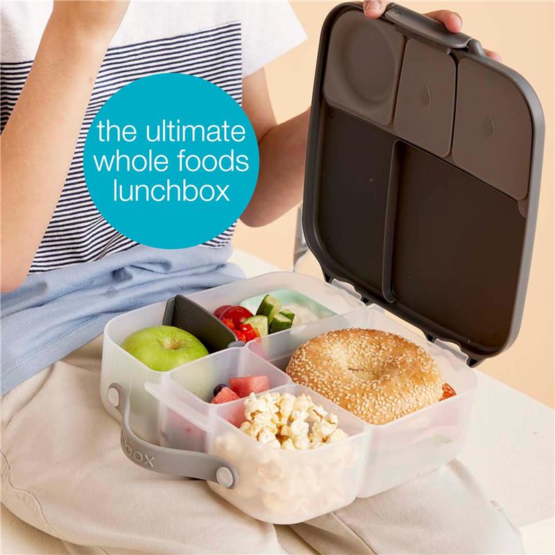 Bbox Lunchbox in Emerald Forest with compartments filled with fruit, vegetables, popcorn, and a bagel.