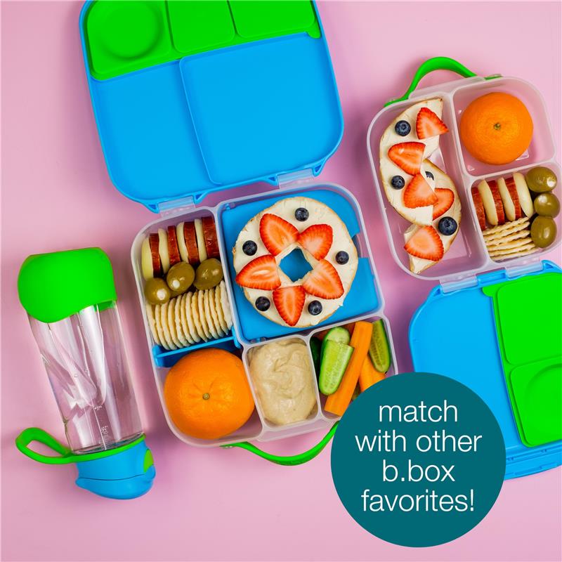 Bbox Lunchbox Midnight with colorful compartments, filled with fruits, crackers, and a drink bottle, on a pink background.