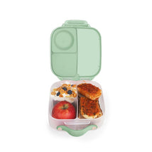 Mini lunchbox in spearmint color, containing an apple, yogurt with granola and berries, and two pieces of baked dish.