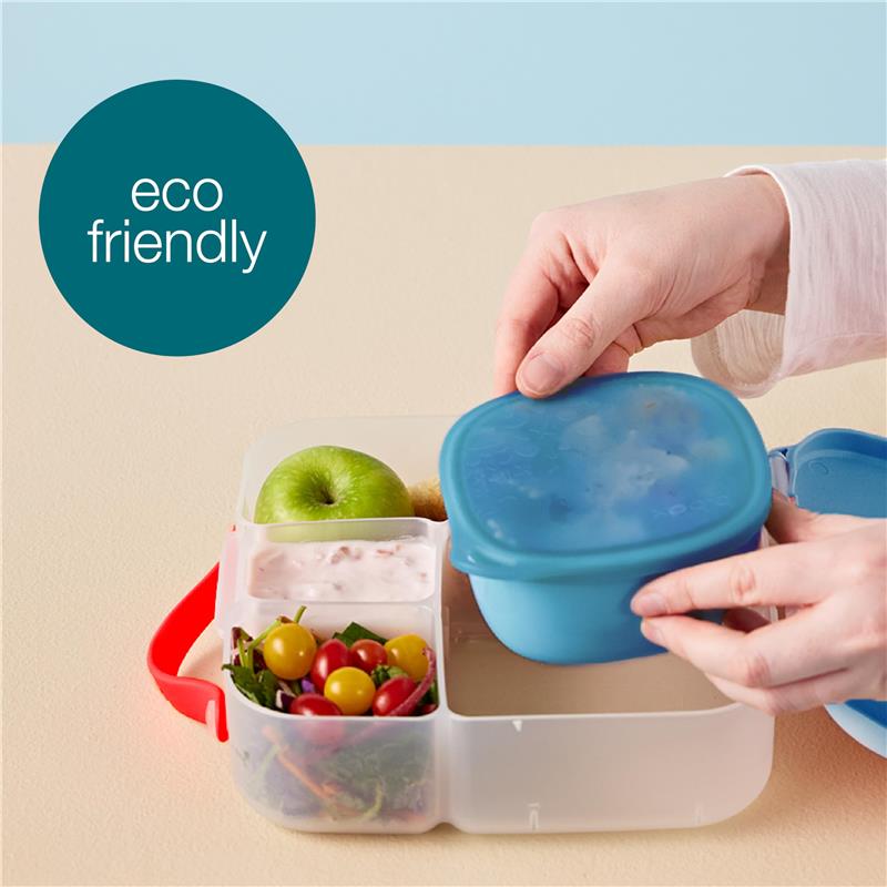 Silicone lunch tub in berry color with sections for food, featuring green apple, yogurt, and mixed salad. Eco-friendly design.