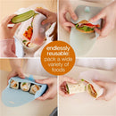 Silicone Sandwich Pocket in Berry color shown being used to pack various foods, highlighting its reusable design.