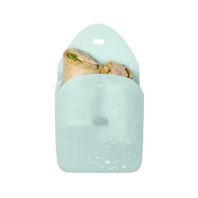 Silicone sandwich pocket in a light green color, holding two wrapped sandwiches with visible ingredients.