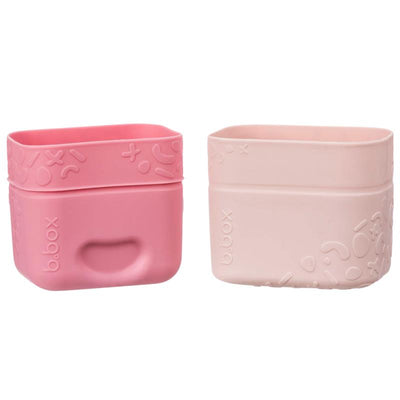 Silicone snack cups in berry colors from b.box, featuring a playful design with textured patterns on the exterior.