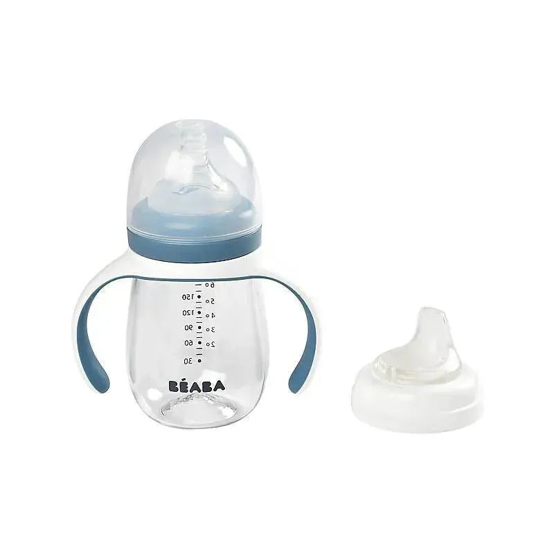 Beaba 2-in-1 bottle to sippy learning cup in clear plastic with blue accents and measurement markings, includes a removable spout.