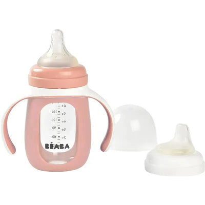 2-In-1 Glass Training Cup by Beaba in rose color, featuring handles and removable lids for easy use.
