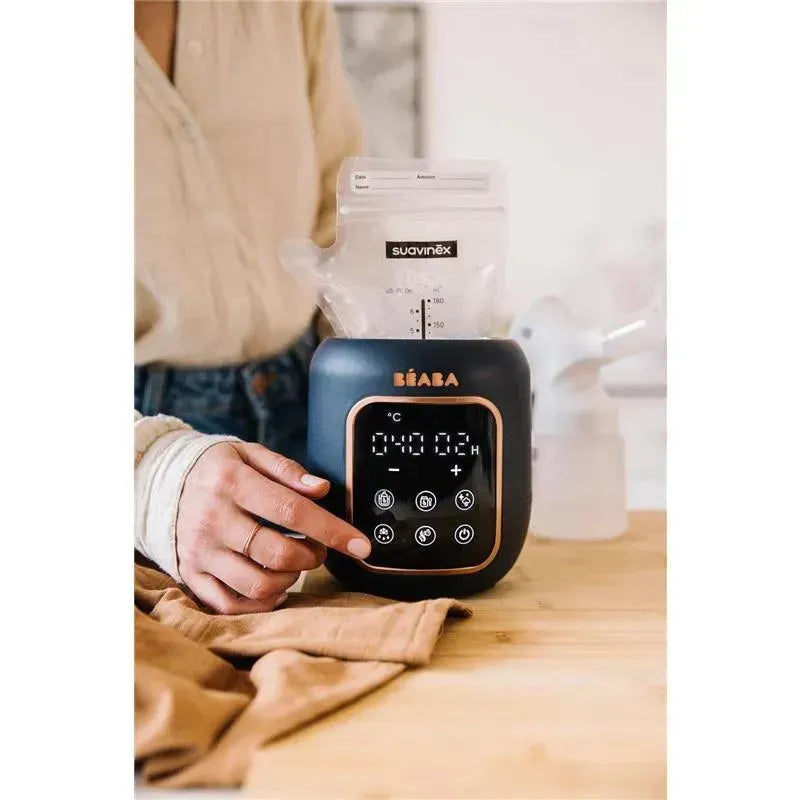 Beaba 5-in-1 Multi Milk Baby Bottle & Food Warmer in Midnight, with digital display and buttons, warming a milk bag.