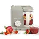 Beaba Babycook Solo 4 in 1 Baby Food Maker in cloud color, with mixed fruits in the jar and a bowl of pureed food beside it.