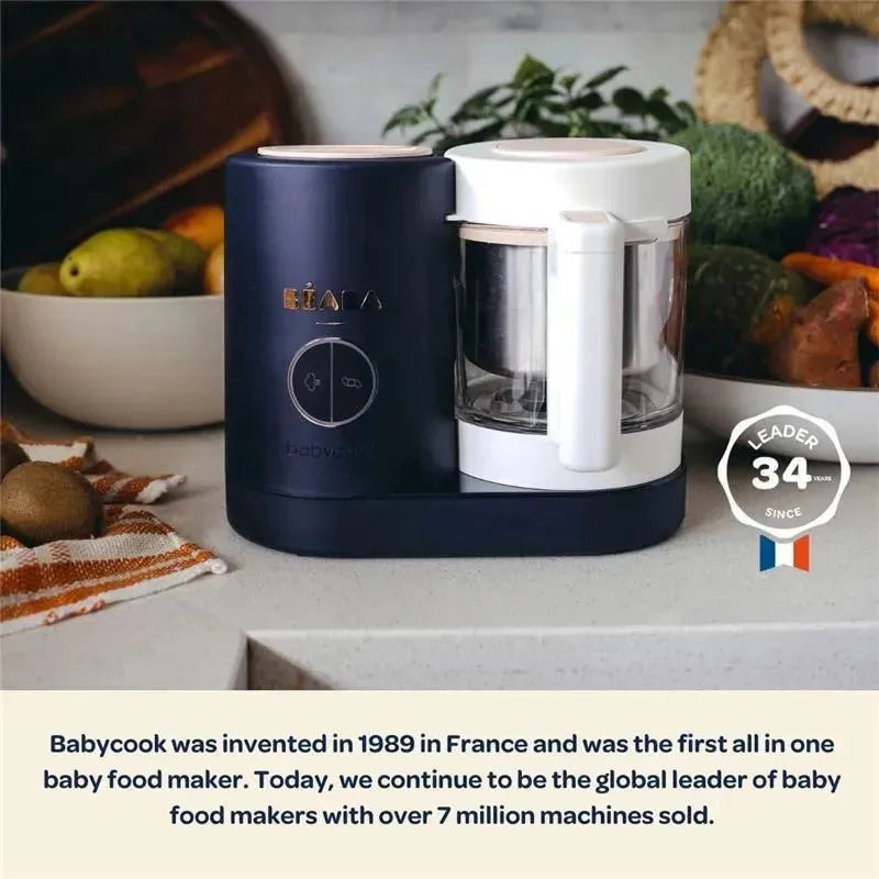 Beaba Babycook Neo in Eucalyptus, a dark blue and white baby food maker, with visible control buttons and blending jar, on a countertop.