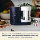 Beaba Babycook Neo in Eucalyptus, a dark blue and white baby food maker, with visible control buttons and blending jar, on a countertop.