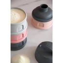 Beaba formula and snack container set in rose and gray, stacked with one container showing powdered contents.