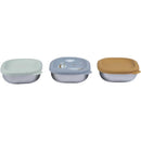 Set of three Beaba stainless steel baby bowls with silicone lids in pastel colors, featuring decorative designs.