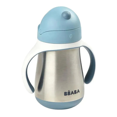 Stainless steel sippy cup with handles by Beaba, featuring a blue lid and a silver body. Ideal for toddlers.