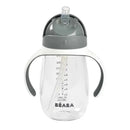 Beaba Straw Sippy Cup in charcoal color with transparent body, measurement markings, and ergonomic handles.
