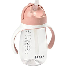 Beaba straw sippy cup in rose color with measurement markings and ergonomic handles for easy grip.