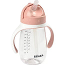 Beaba straw sippy cup in rose color with measurement markings and ergonomic handles for easy grip.
