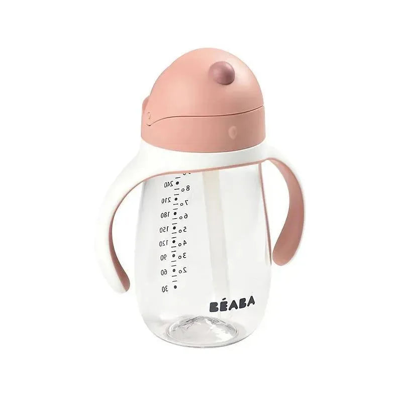 Beaba Straw Sippy Cup in rose color with measuring scale, ergonomic handles, and clear plastic body.
