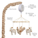 Plush farm animals including cows, a chicken, and a duck hang from a natural wood mobile that plays lullabies.