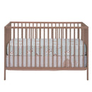 Sage green fitted crib sheet with farm animal prints on a wooden crib, suitable for a baby nursery.
