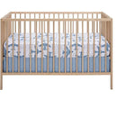Crib with a Little Aviator crib sheet featuring airplane patterns in shades of blue and white.