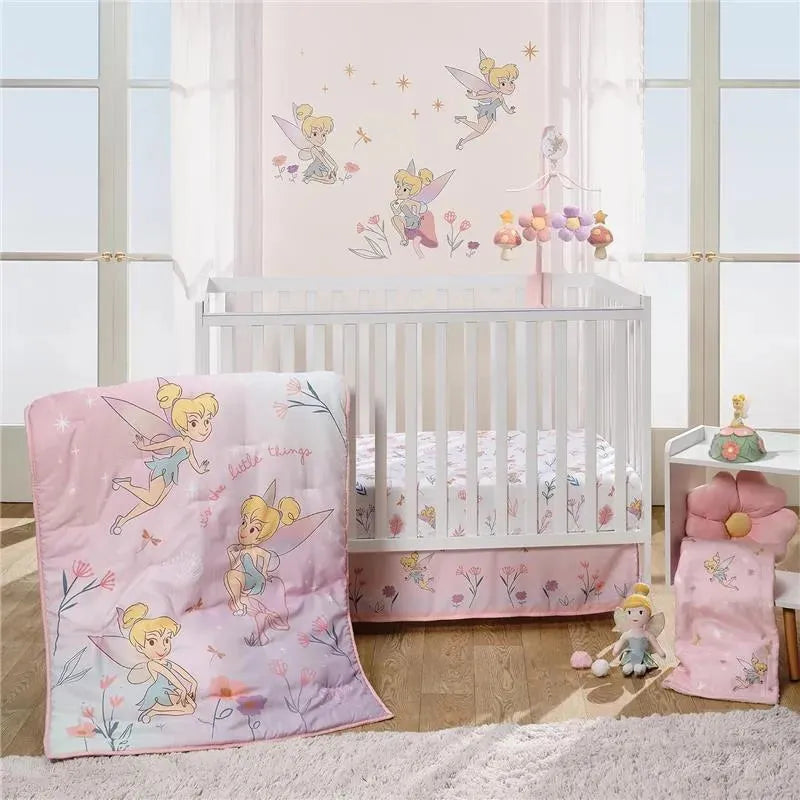 Tinker Bell wall decals and bedding displayed in a nursery with pastel colors and floral designs.