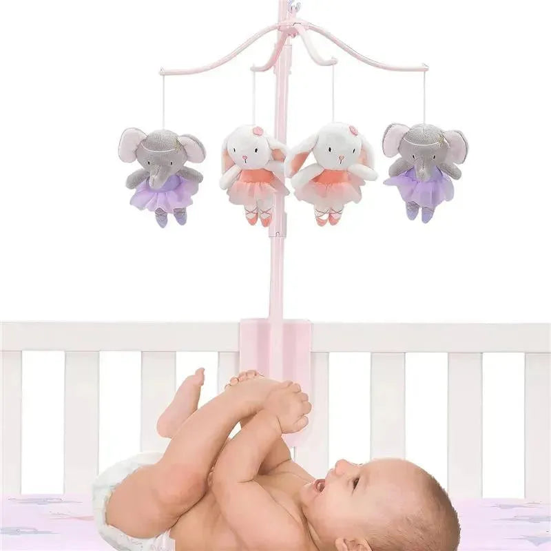 Tiny Dancer Musical Mobile features plush ballet-dancing elephants and bunnies, hanging above a baby in a crib.