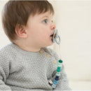 Boy with short hair using a Bella Tunno pacifier clip with colorful beads attached to a pacifier.