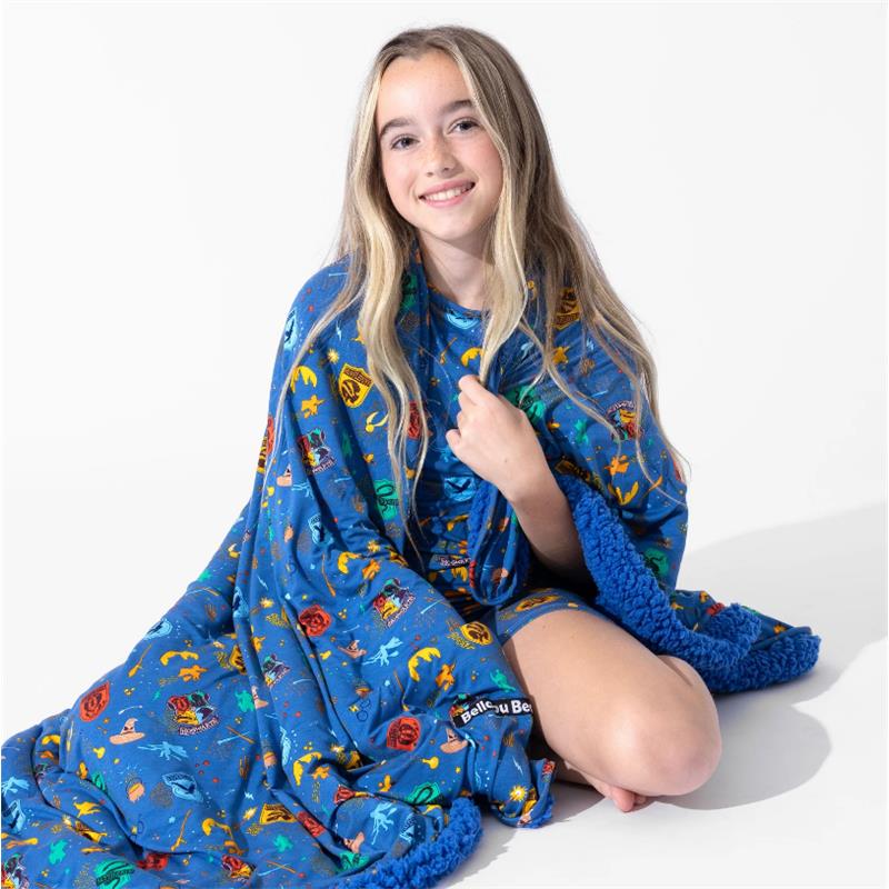 Bamboo adult robe blanket with colorful Harry Potter-themed designs, worn by a smiling girl sitting on the floor.