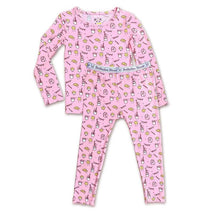 Pink bamboo pajamas for kids featuring a pattern of milk and cookies, sized for 18-24 months.