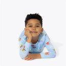 Bamboo kids pajamas featuring Spongebob Squarepants characters, worn by a smiling child lying on their stomach.