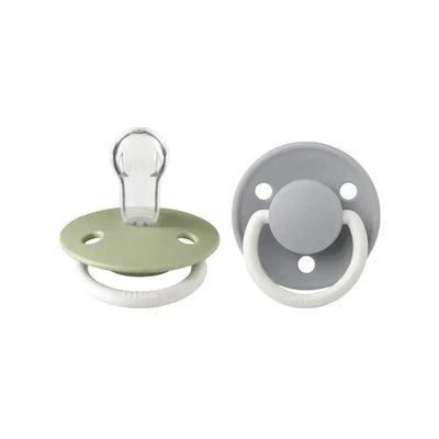 Silicone pacifiers in sage and cloud colors, featuring soft, round shields and ring handles for easy gripping.