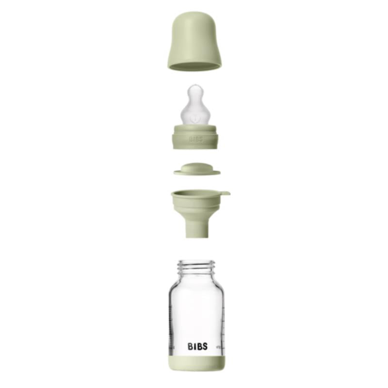 Baby 4oz silicone glass bottle with bumper in sage, showing all components: cap, nipple, seal, and glass container.