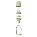 Baby 4oz silicone glass bottle with bumper in sage, showing all components: cap, nipple, seal, and glass container.