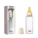 Baby plastic bottle with latex nipple, 270ml, ivory color, shown with packaging and cap. Suitable for infants.