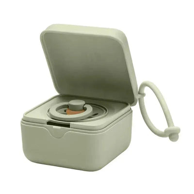 BIBS pacifier box in sage color, showcasing an open design with a pacifier inside and an attached loop for easy carrying.