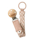 Bibs pacifier clip in blush and ivory, featuring a wooden clip and braided fabric strap.