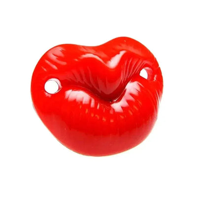 Red pacifier shaped like a pair of lips, designed for playful use, featuring two holes on the sides for attachment.