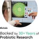 Biogaia product display featuring a computer screen showing probiotic research results, highlighting bacteria colonies and research data.