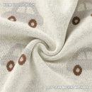 Luxury cotton baby blanket in cream featuring car and donut patterns, highlighting warmth, lightweight, and machine washable care.