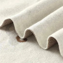 Luxury cotton receiving swaddle baby blanket in cream color with subtle car print details and textured waves.